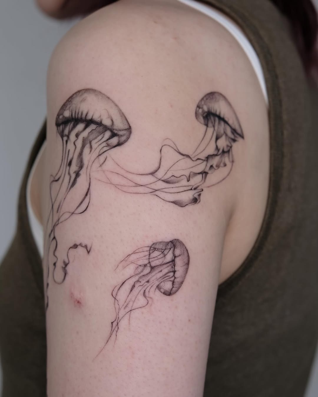 Elegant Jellyfish Tattoo on Upper Arm Tattoo Design