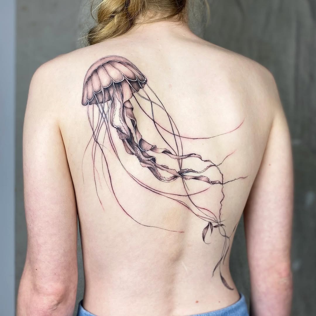 Graceful jellyfish tattoo design on the back Tattoo Design