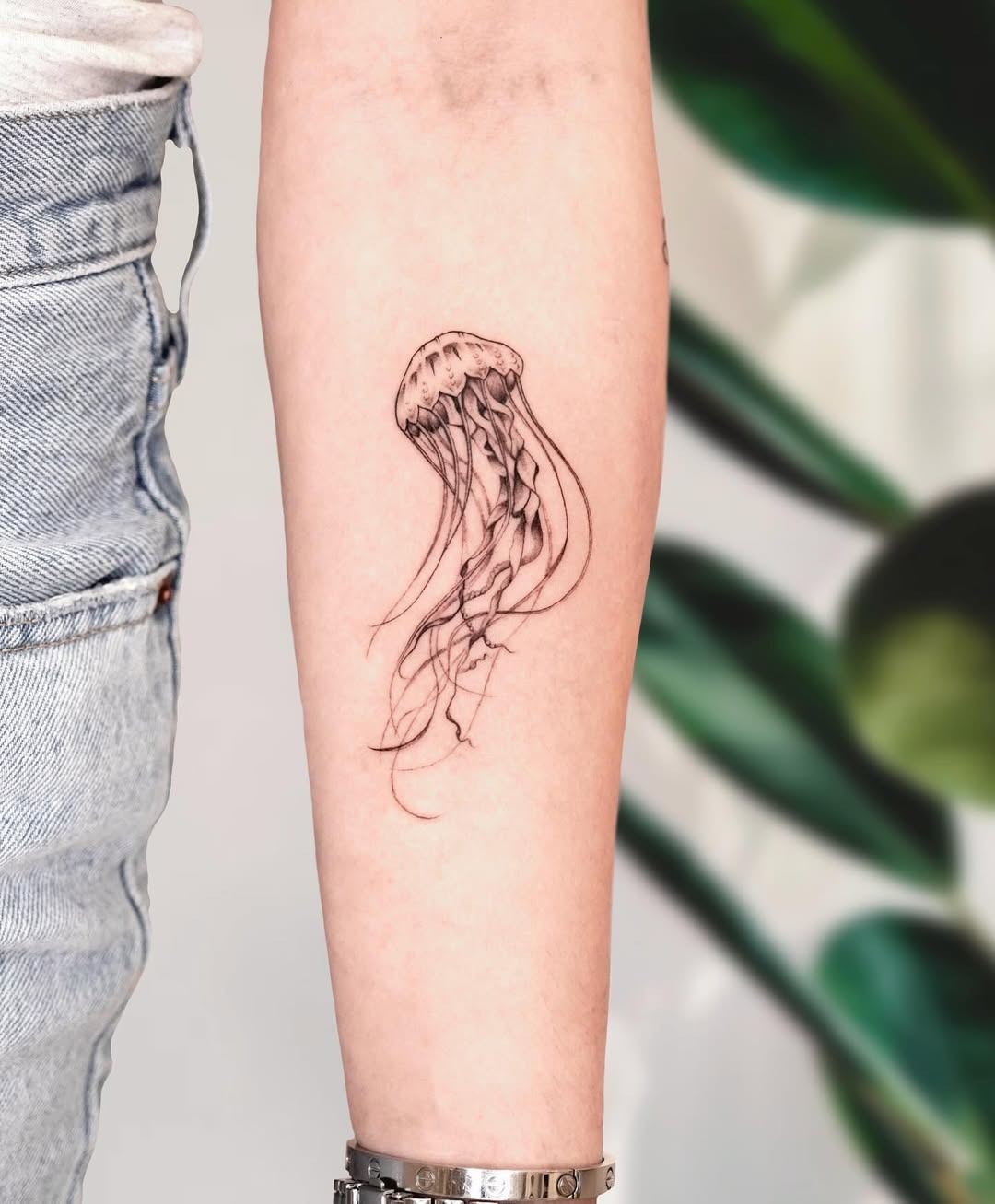 Minimalist jellyfish tattoo on the forearm Tattoo Design