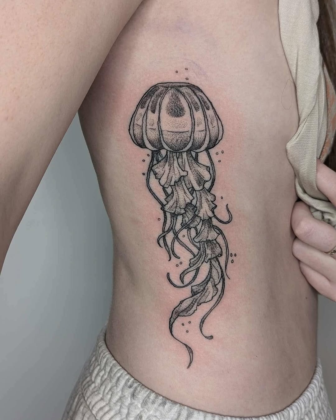 Stunning jellyfish tattoo on rib cage Tattoo Design