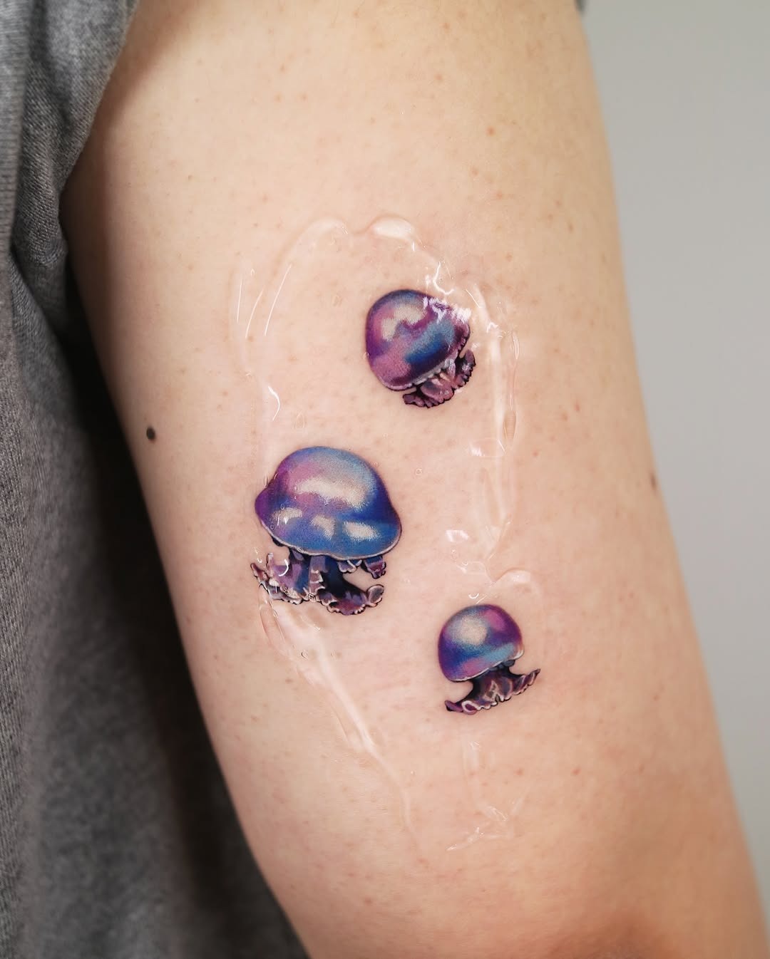 Vibrant jellyfish tattoos with a watercolor style Tattoo Design