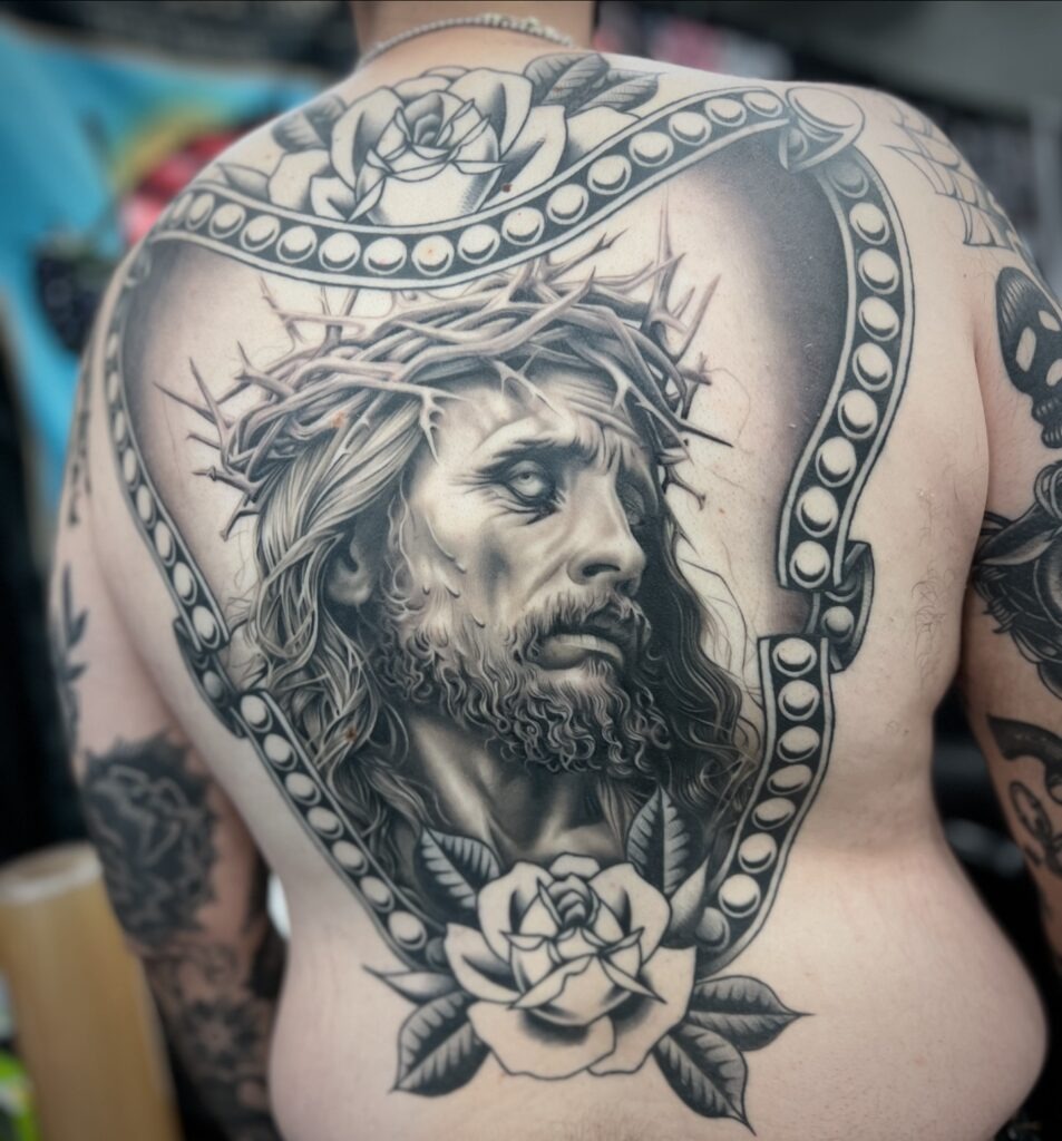 Framed in Devotion: Jesus and Roses Back Tattoo Tattoo Design