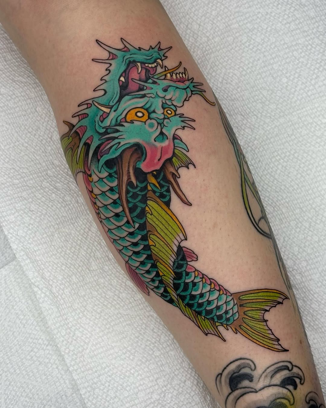 This koi fish tattoo features bright colors and intricate designs, showing the beauty of the fish.