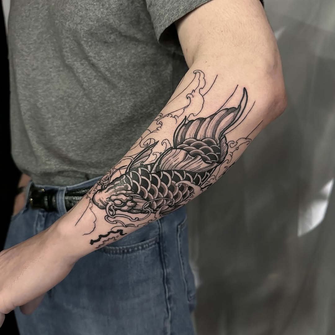 This striking koi fish tattoo features intricate black ink designs flowing around the arm.