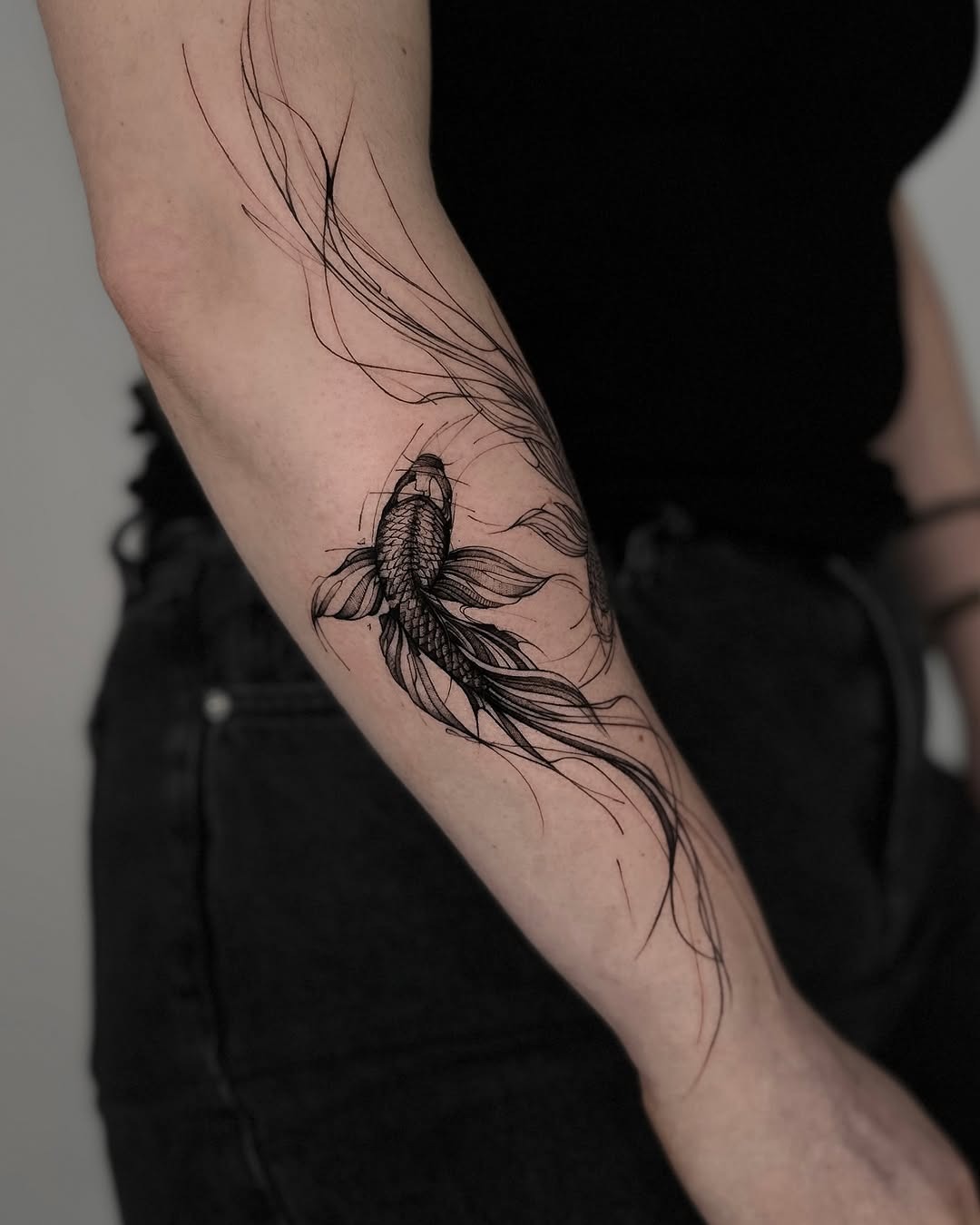 This stunning koi fish tattoo features flowing lines that create a minimalist aesthetic.