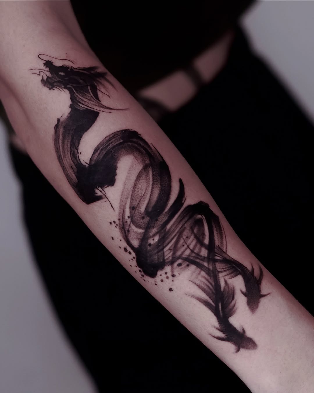 This stunning tattoo features a flowing koi fish elegantly inked in black.