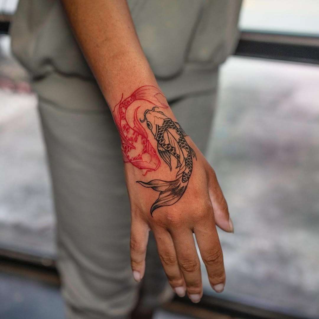 This stunning tattoo features a koi fish intertwined with a bold black outline.
