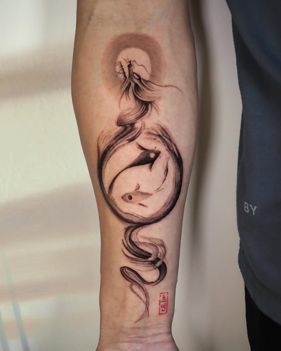 This tattoo showcases an elegant koi fish entwined in flowing lines, creating a sense of movement and serenity.