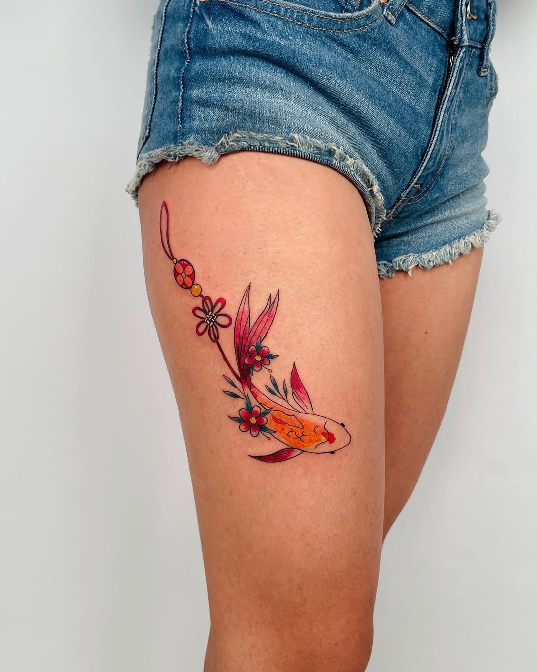 This stunning koi fish tattoo is beautifully designed with colors that pop against the skin.