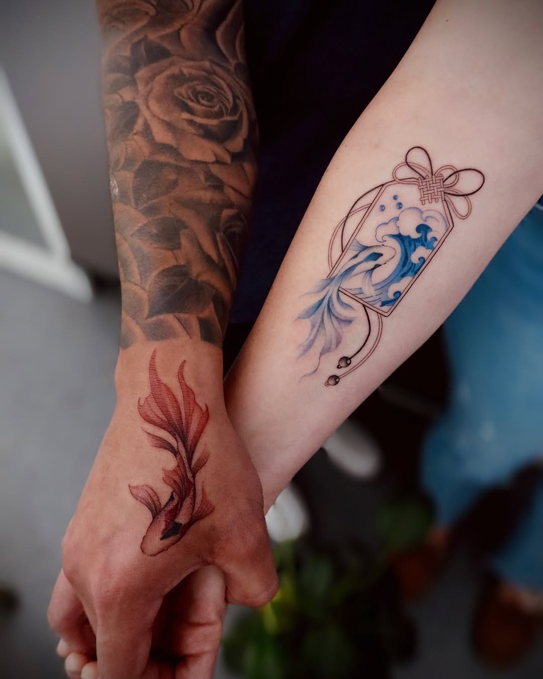 This image features two striking koi fish tattoos: one in vivid colors, illustrating the fish swimming through stylized waves, and the other in bold blackwork, emphasizing intricate details.