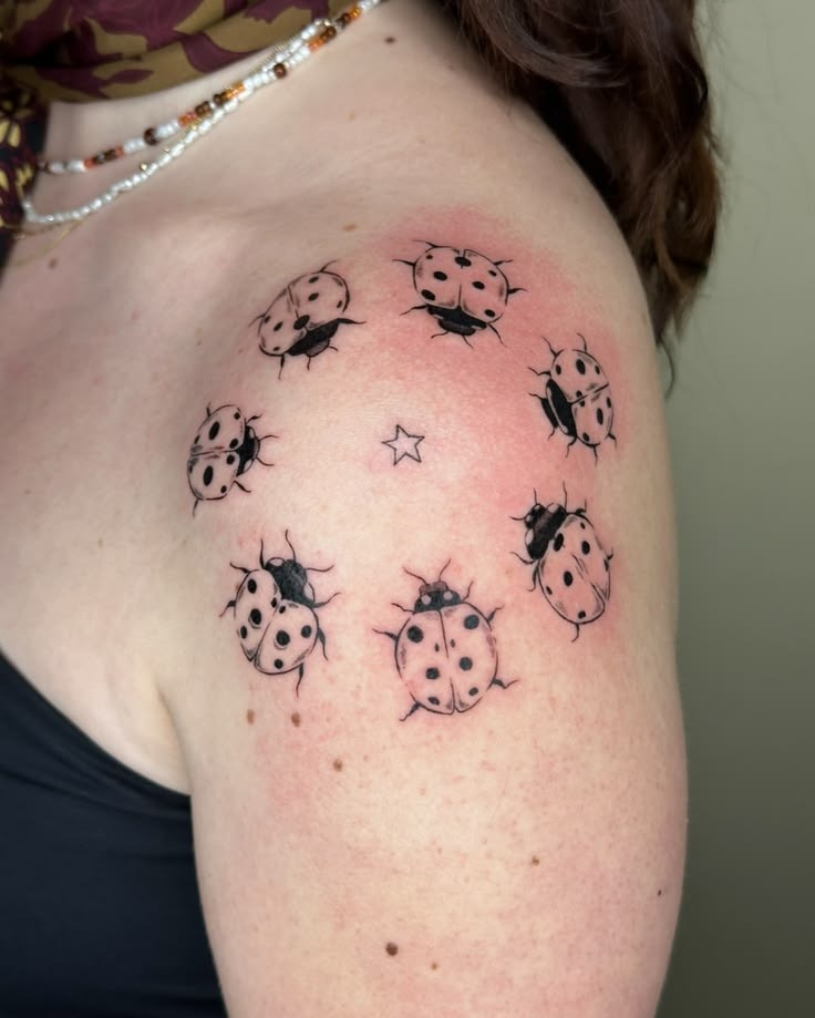 Seven Ladybugs Circling a Tiny Star Tattoo Tattoo Design
