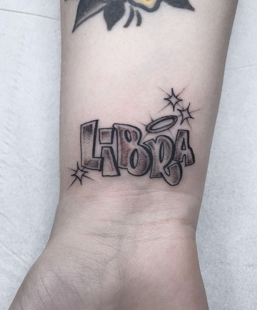 Playful "LIBRA" Script Wrist Tattoo Design