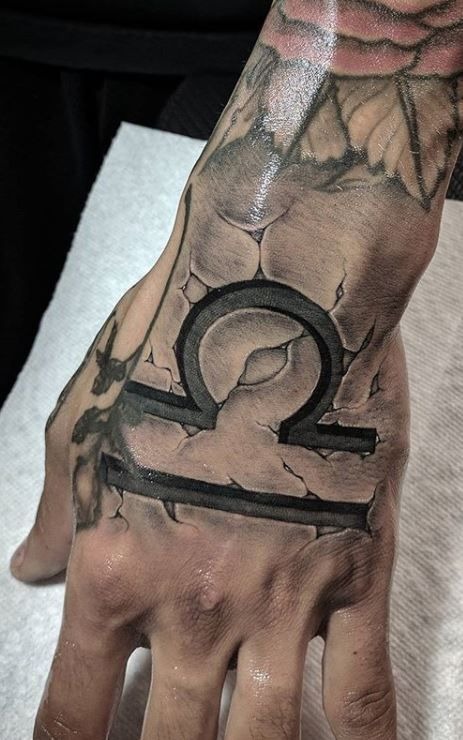 Stone-Set Libra Hand Emblem Tattoo Design