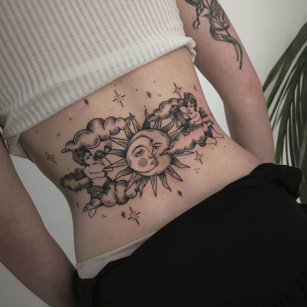 This celestial tattoo combines the sun, moon, and clouds with angelic figures, creating a dreamy composition.