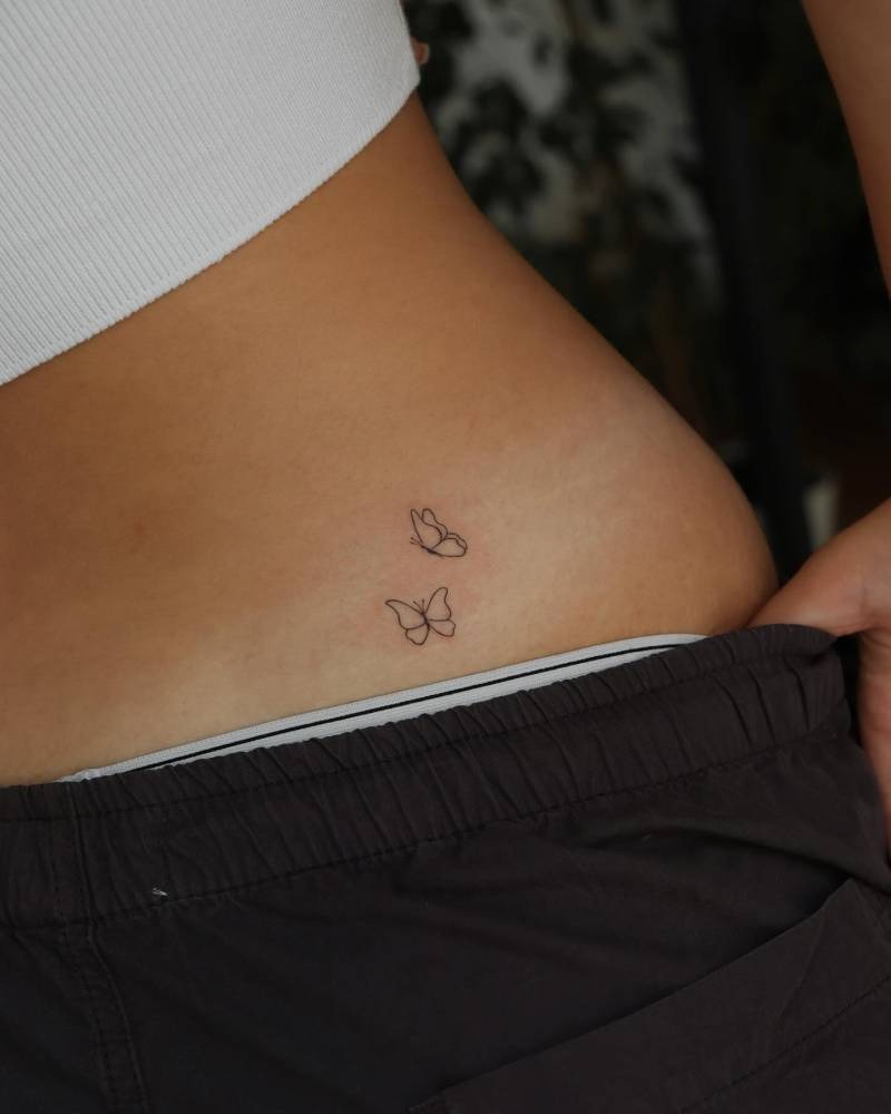 This design features two tiny butterflies gracefully fluttering along the lower back.