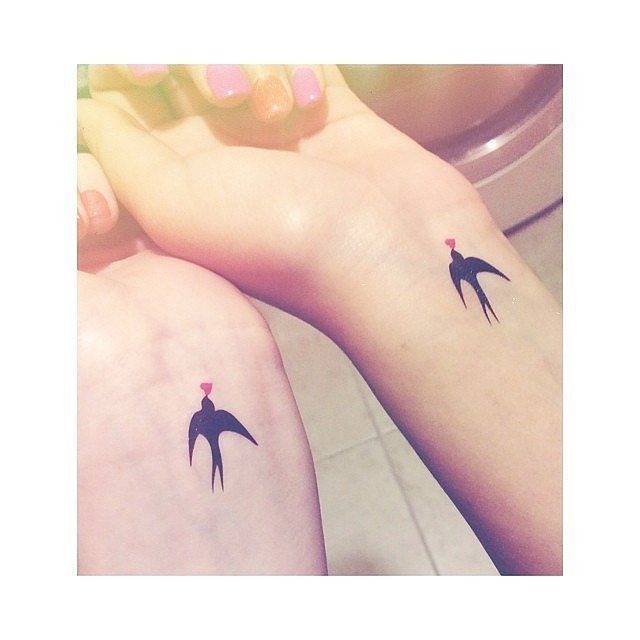 A compass with Feather matching Tattoos on two Women Tattoo Design