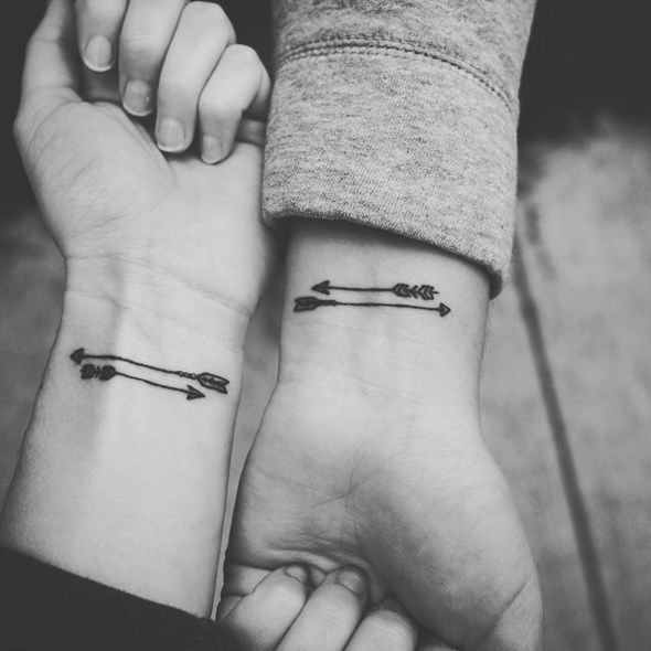 Two butterfly tattoos with skull in the middle Tattoo Design