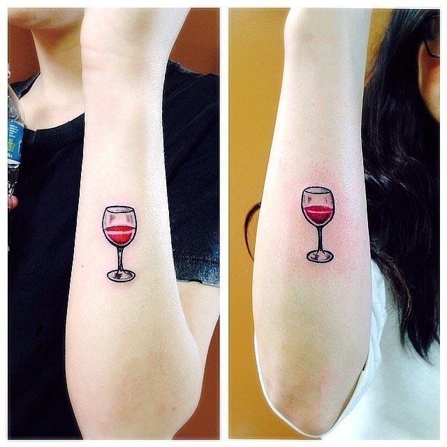 Two Women with Matching Anchor Tattoos on their Ankles Tattoo Design