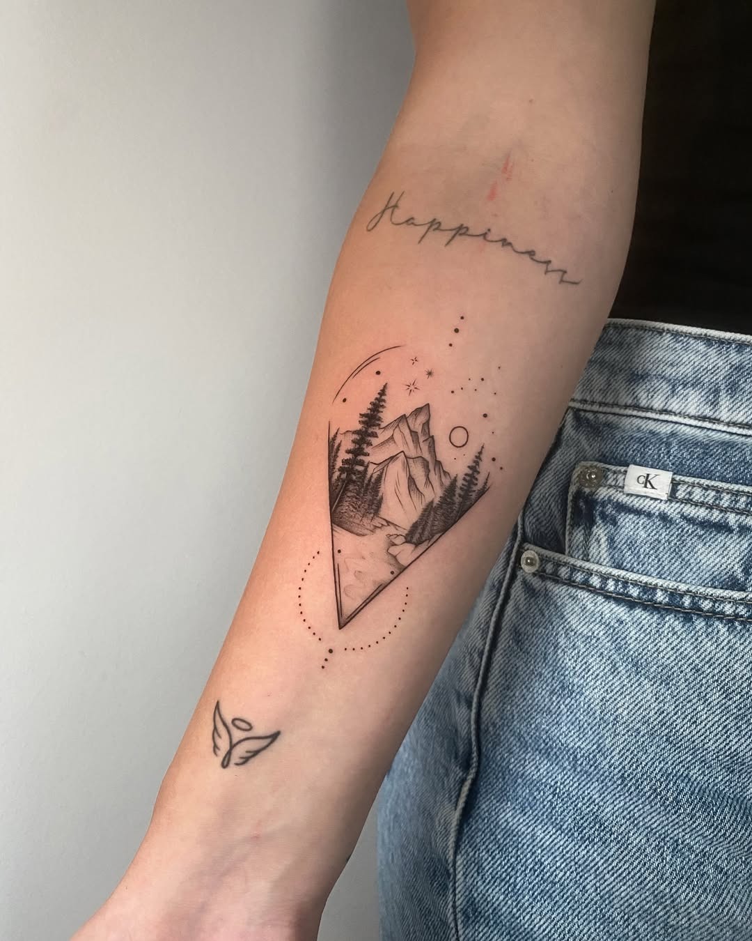 Minimalist Mountain Tattoo with Cosmic Elements Tattoo Design
