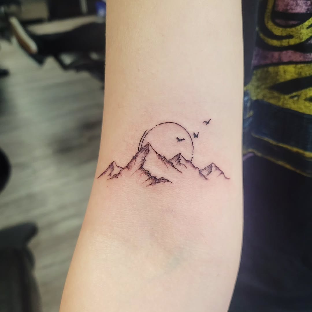 Minimalist mountain tattoo with sunset vibes Tattoo Design