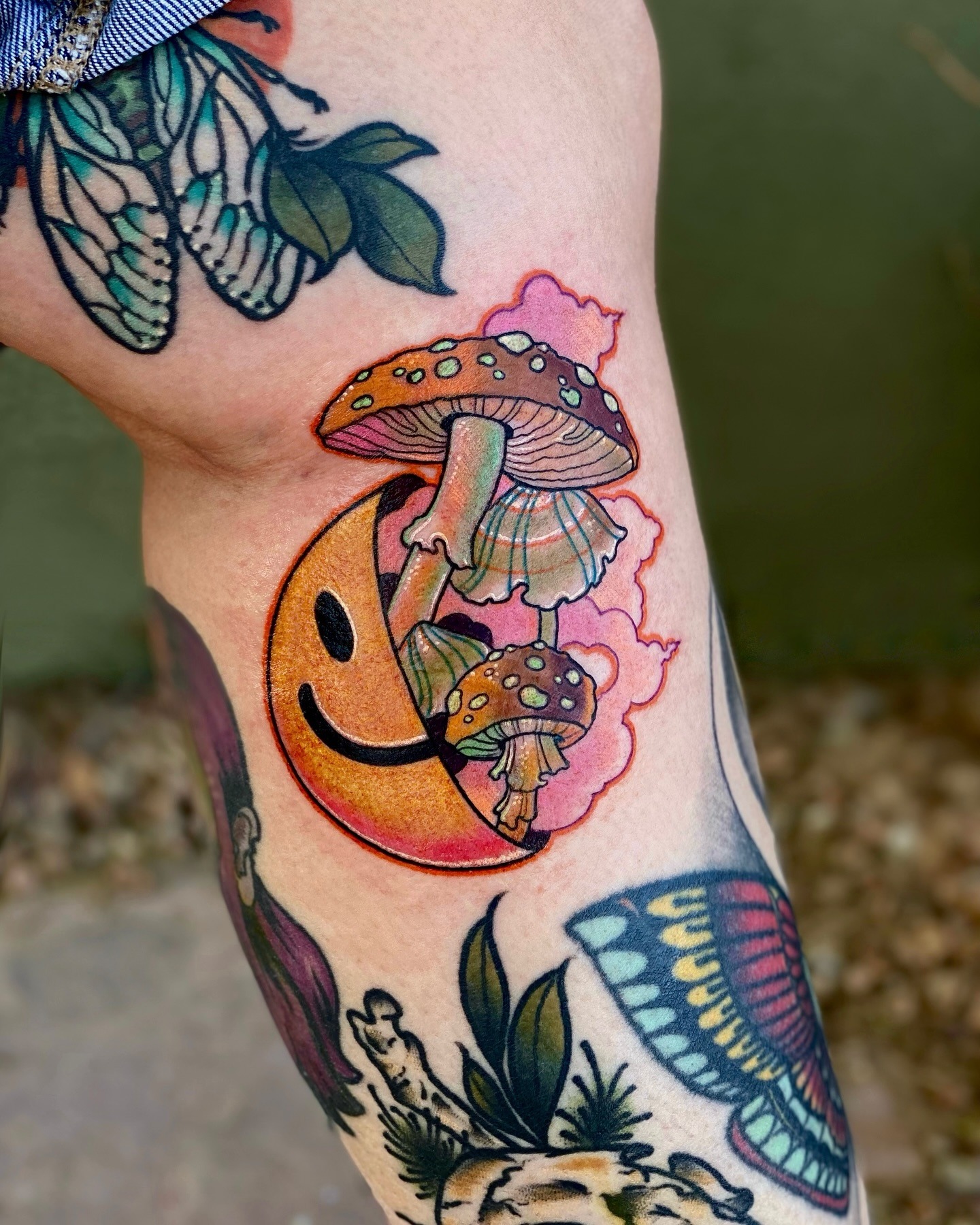 Psychedelic Mushroom Tattoo with Smiley Face and Pink Clouds Tattoo Design