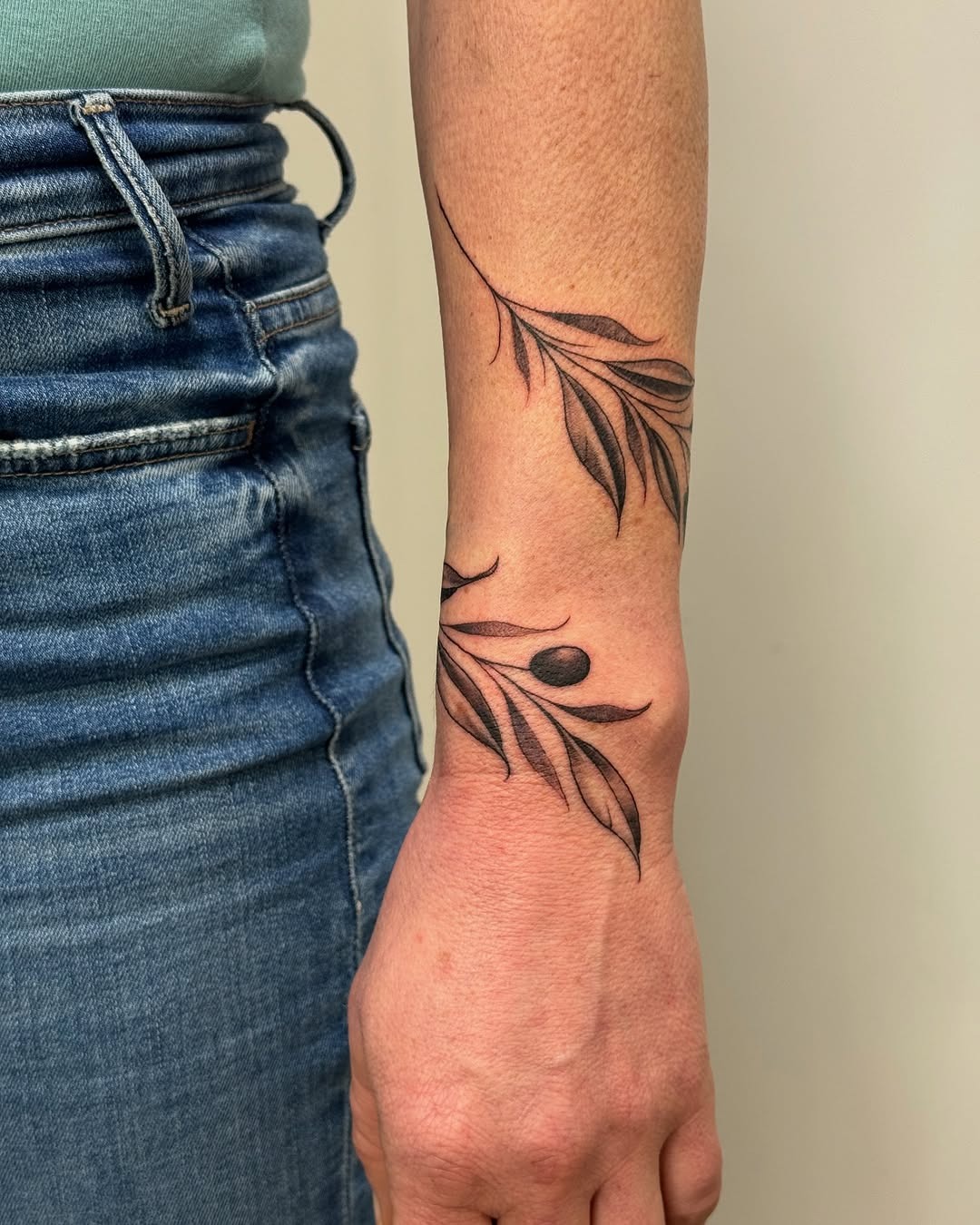 Elegant olive branch tattoo for subtle expression Tattoo Design