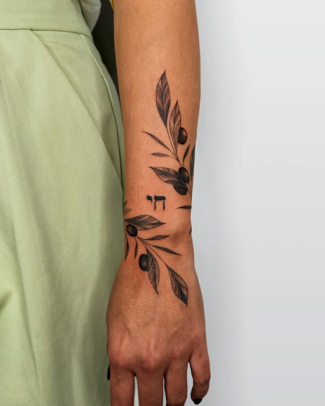 Elegant olive branch tattoo on arm Tattoo Design