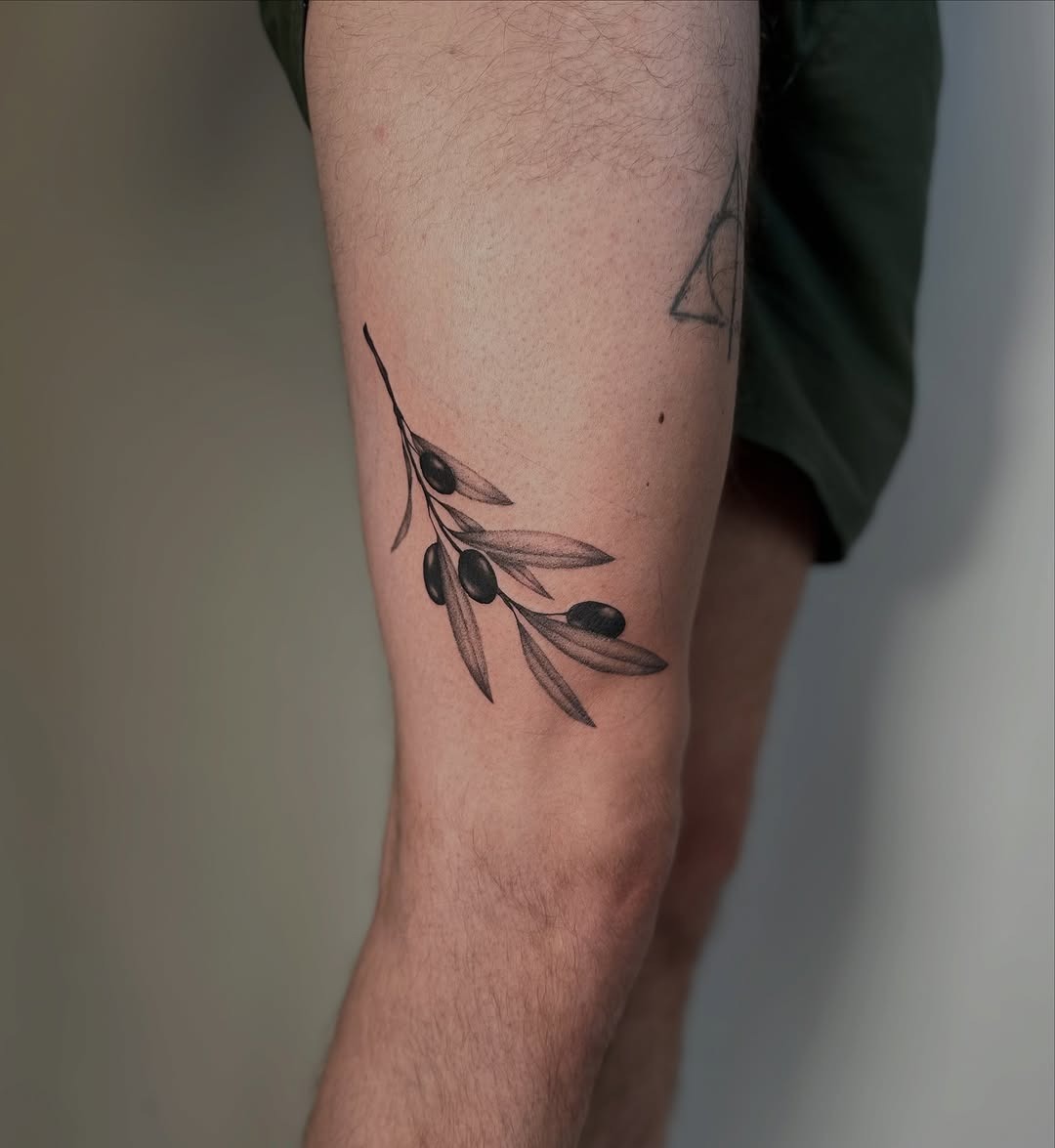 Elegant olive branch tattoo on thigh Tattoo Design