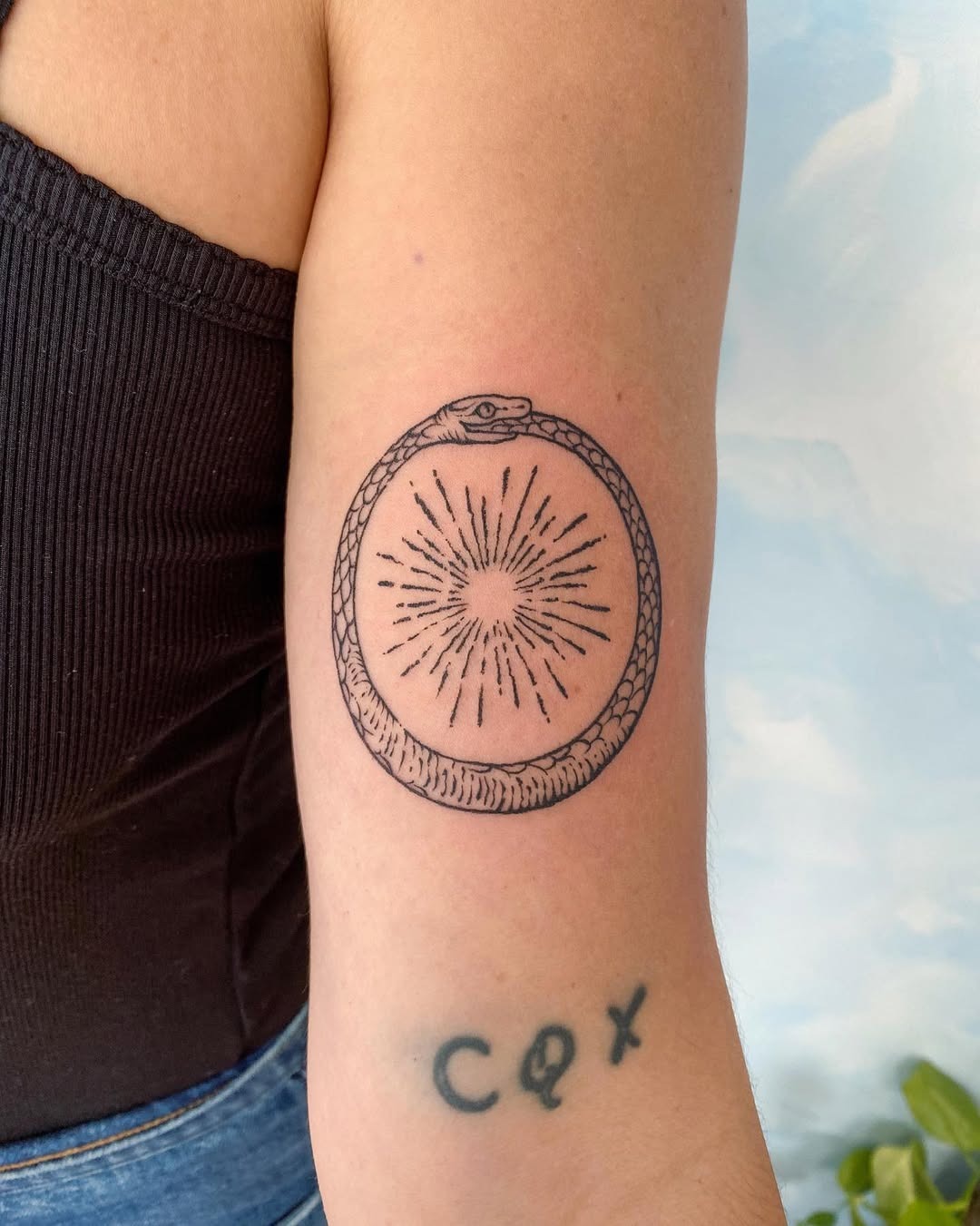 A mesmerizing ouroboros tattoo with sun rays Tattoo Design