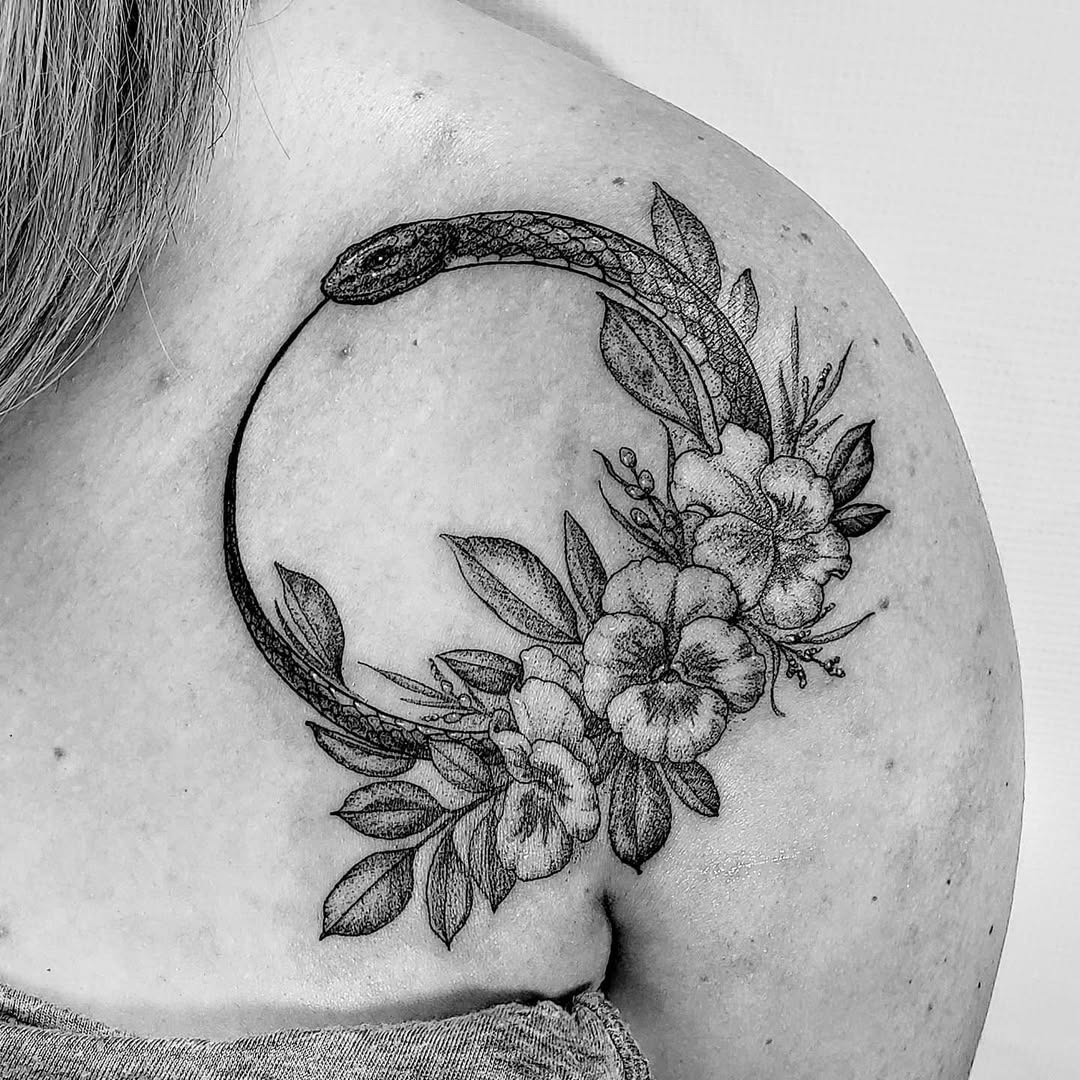 Elegant Ouroboros Tattoo with Floral Accents Tattoo Design