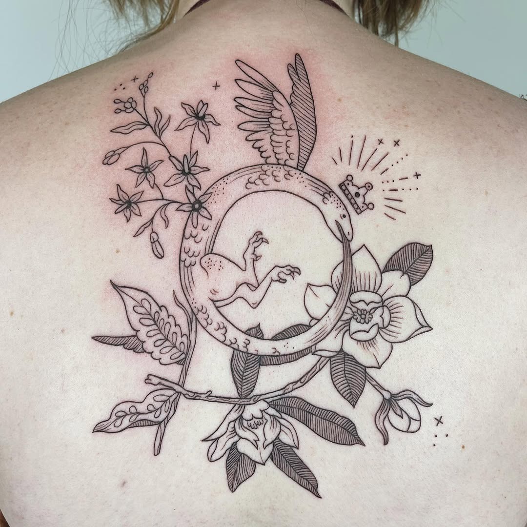Elegant Ouroboros Tattoo with Floral Details Tattoo Design