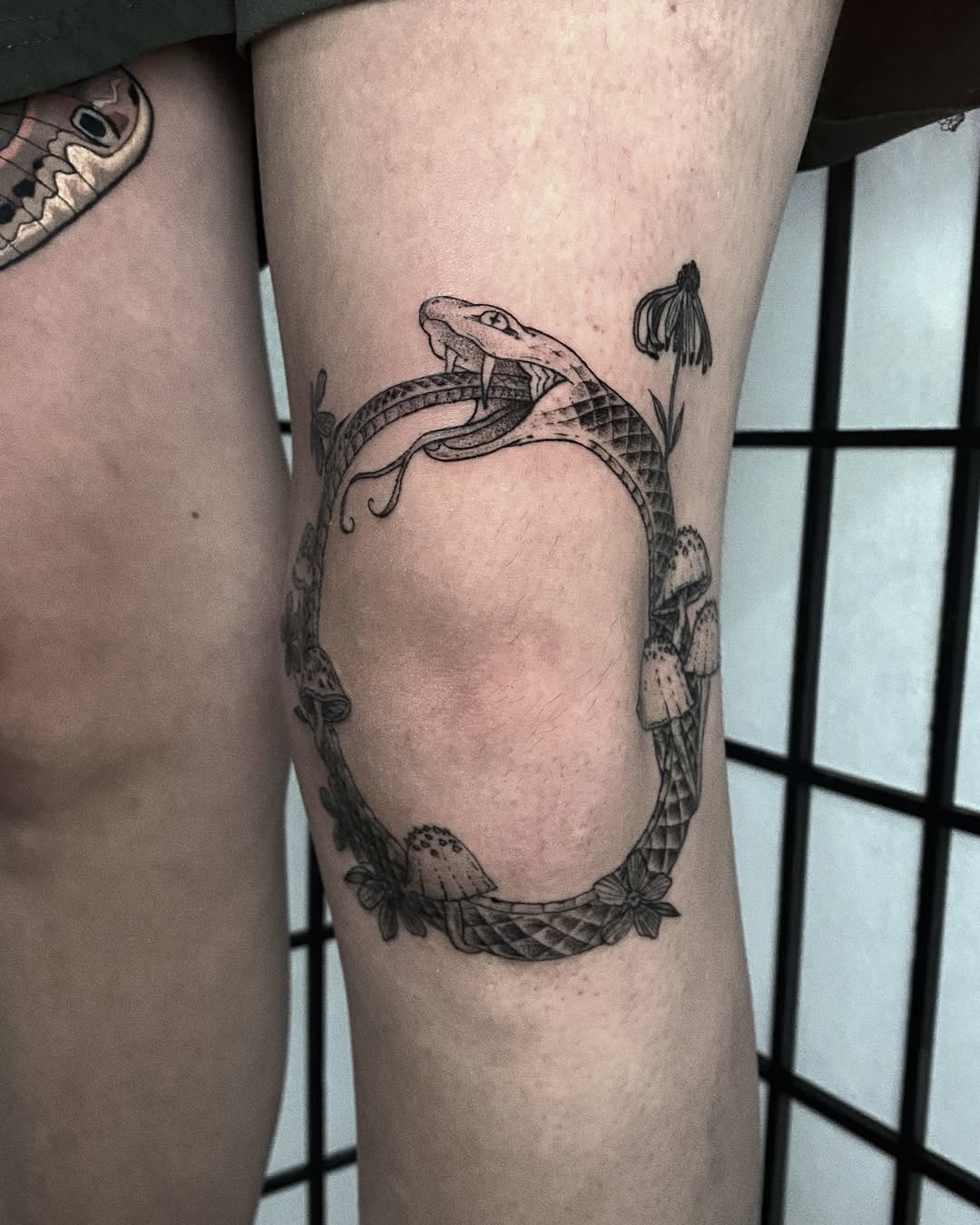 Intricate ouroboros design with floral elements Tattoo Design