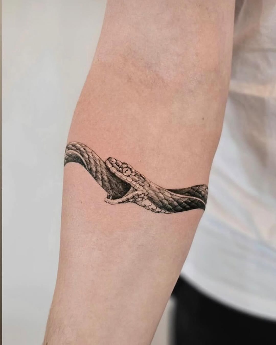 Intricate ouroboros tattoo wrapped around arm Tattoo Design