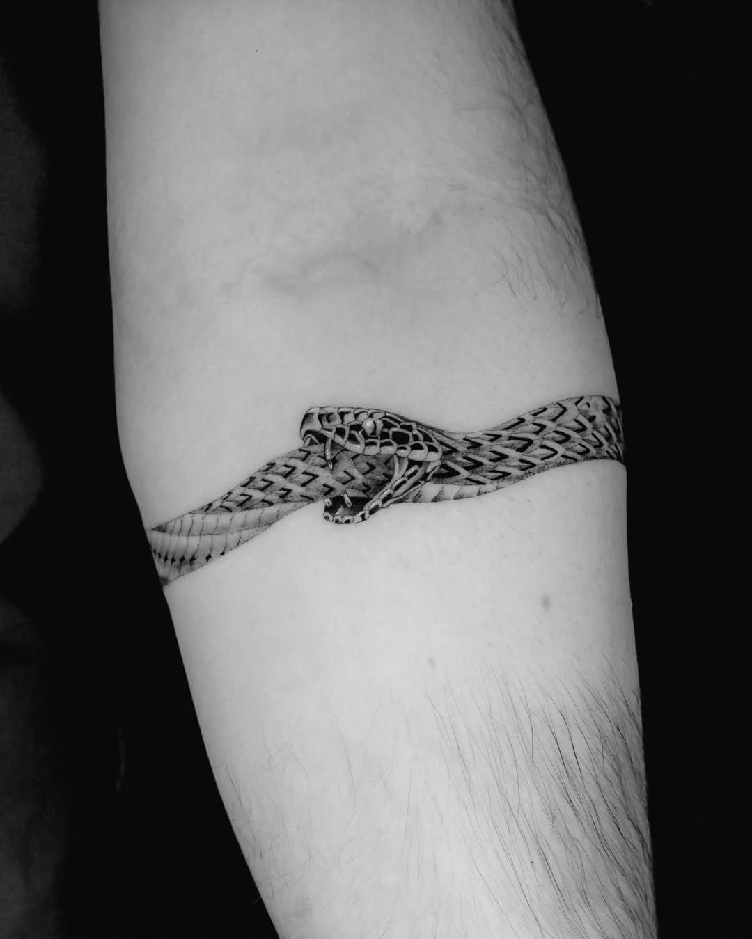 Intricate ouroboros tattoo wrapped around arm Tattoo Design