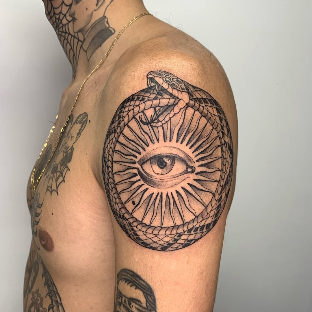 Intricate Ouroboros with Eye and Sun Motif Tattoo Design