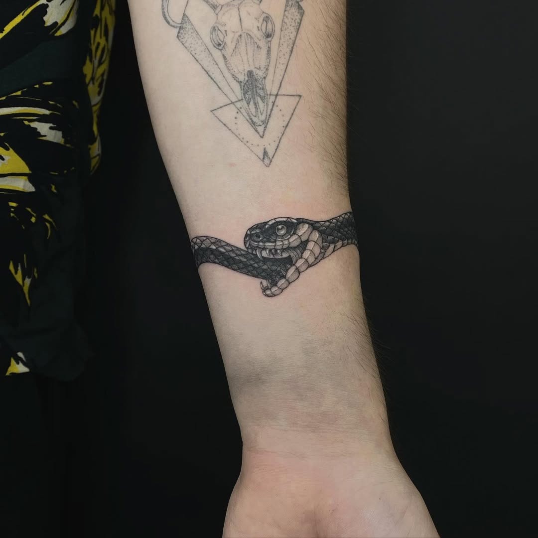 Intriguing ouroboros tattoo wrapped around forearm Tattoo Design