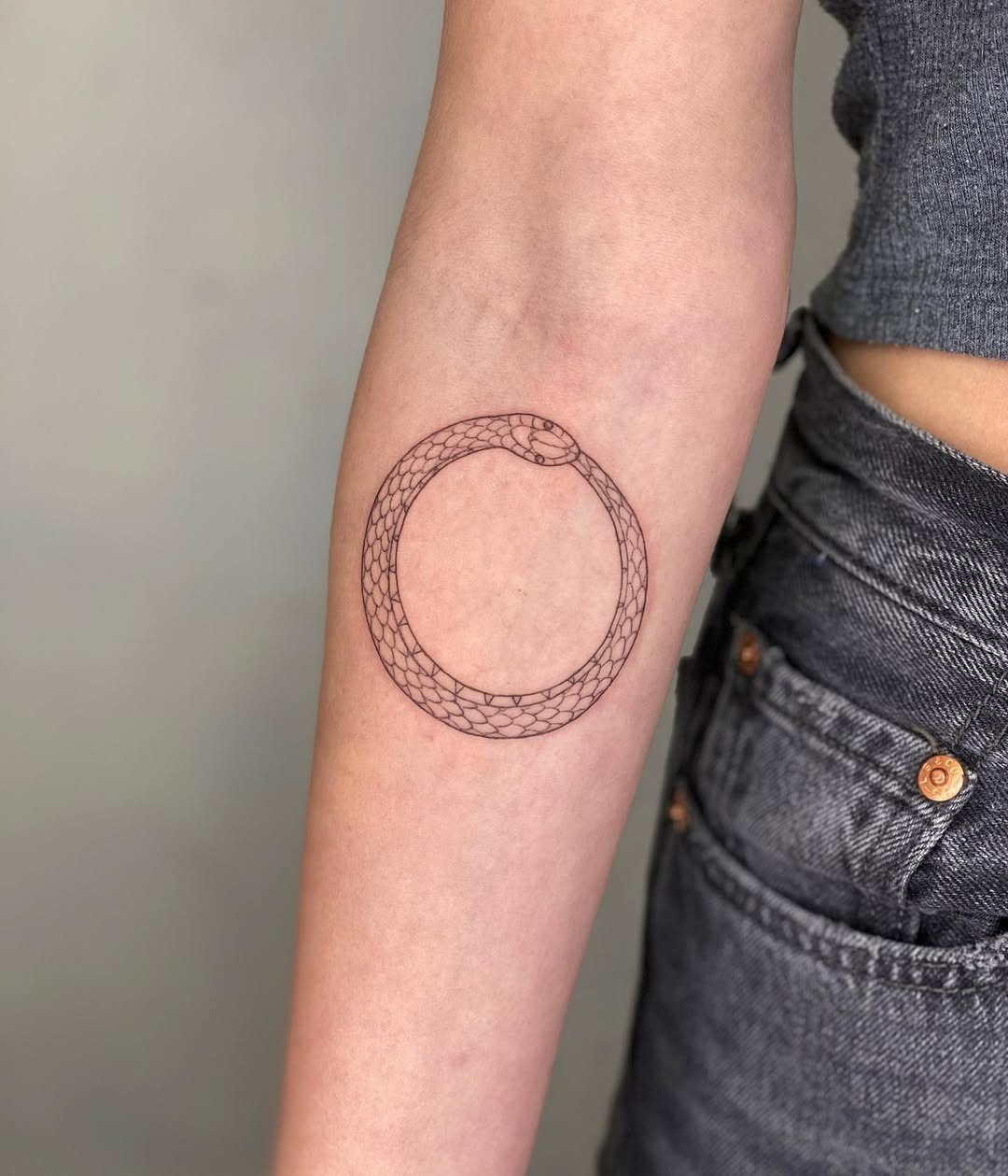 Minimalist Ouroboros Tattoo Design on Arm Tattoo Design