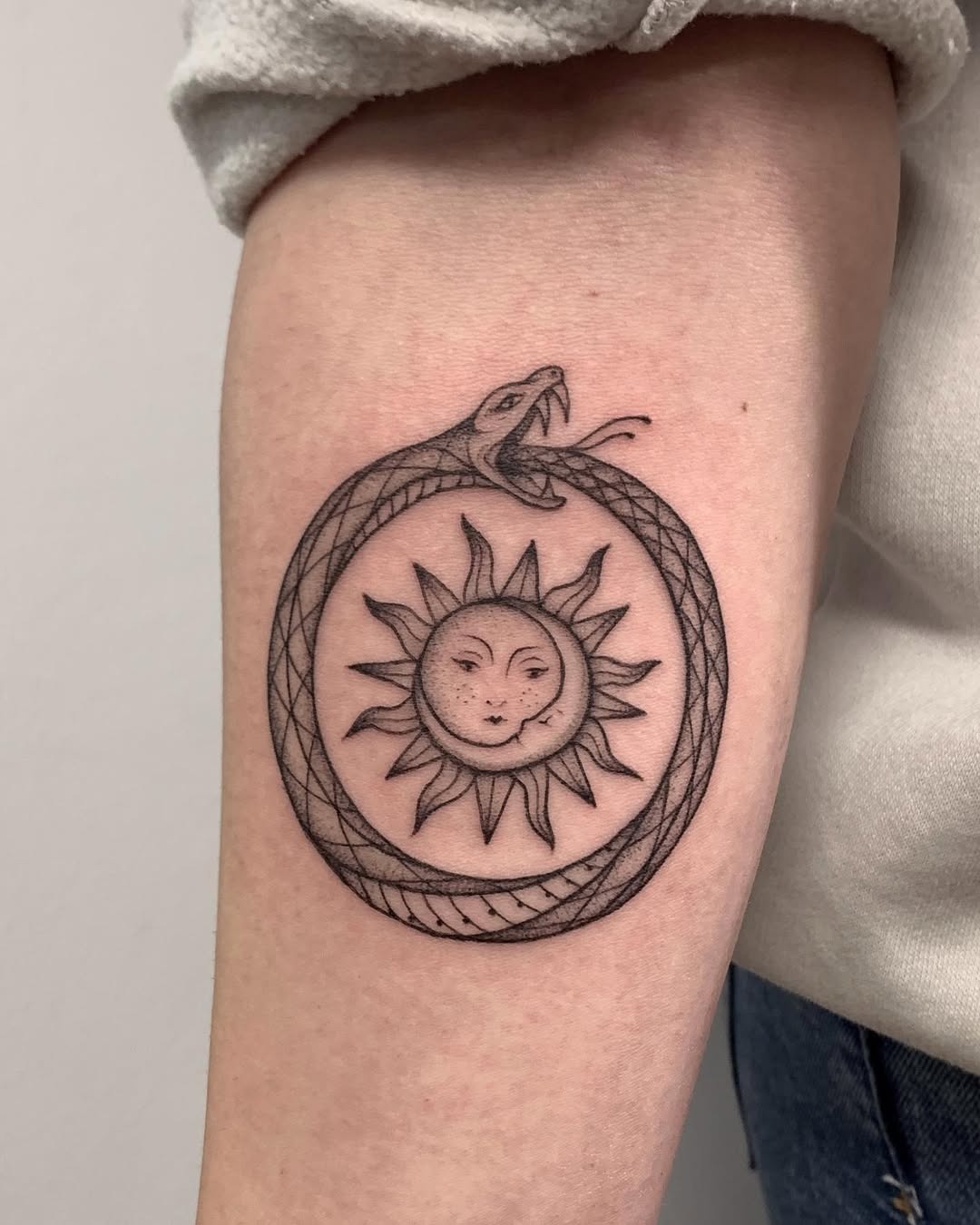 Ouroboros Snake Embracing a Sun Tattoo Design