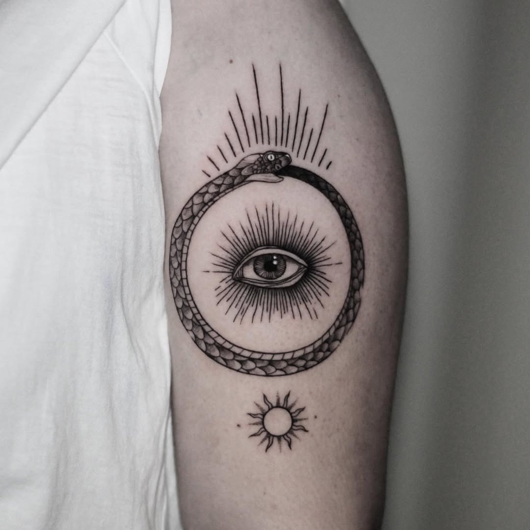 Stunning ouroboros design with sun and eye Tattoo Design