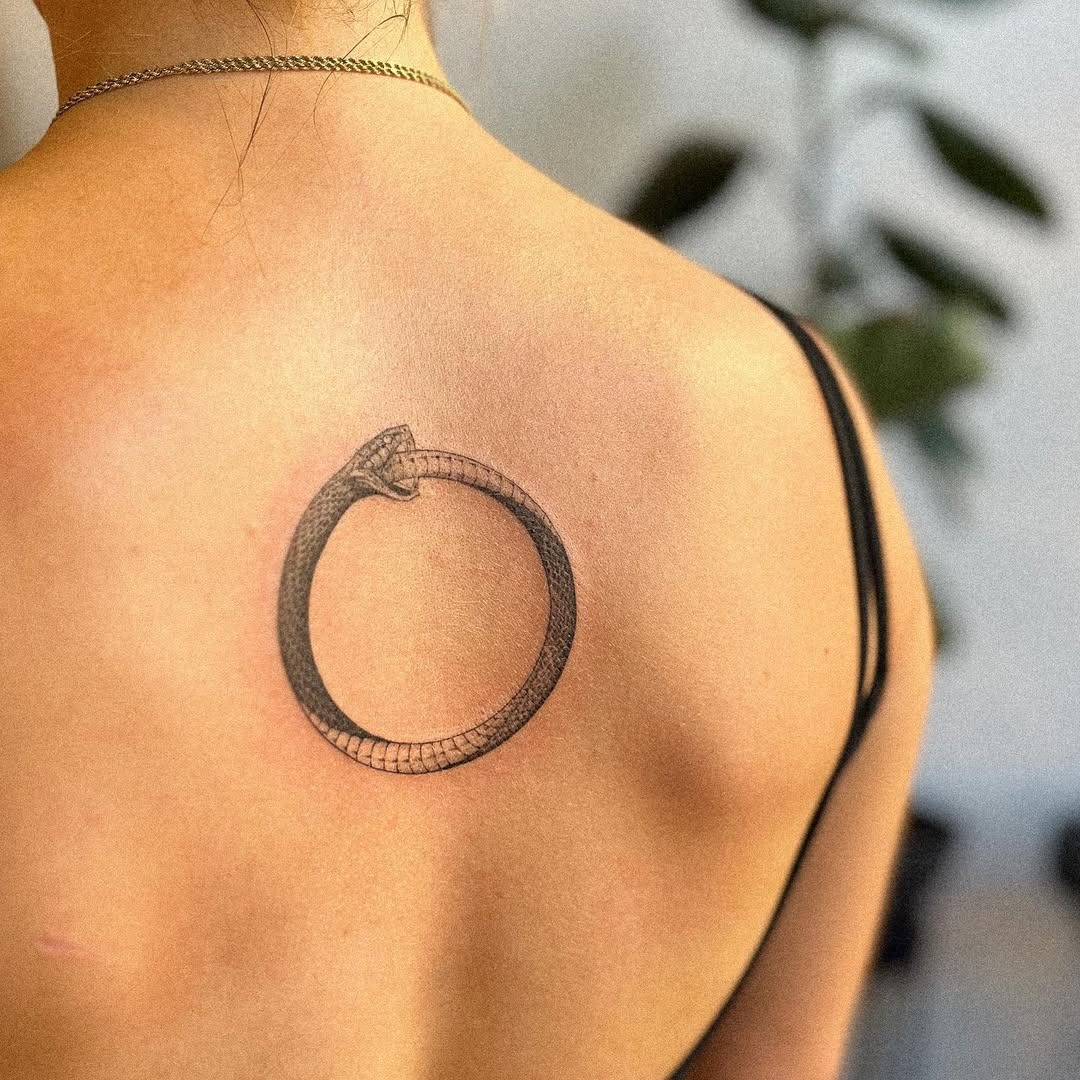 Stylish Ouroboros Tattoo on the Upper Back Tattoo Design