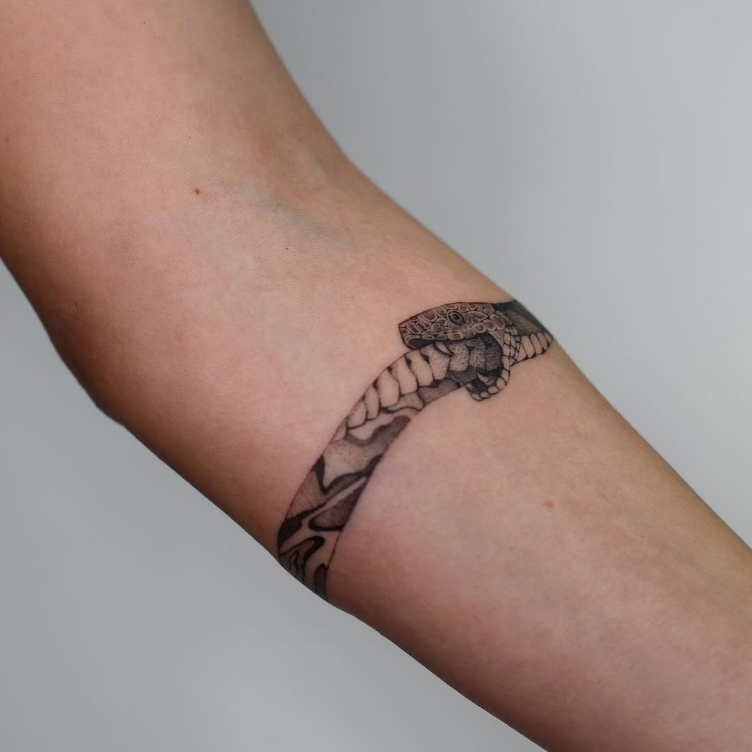 Stylish ouroboros tattoo wrapping the arm Tattoo Design