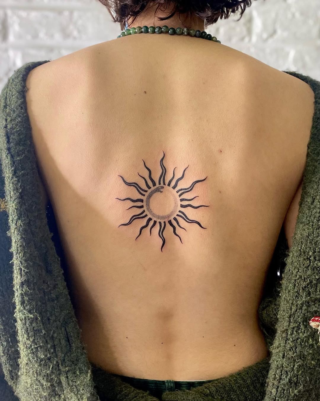 Symbolic sun design in minimalist tattoo art Tattoo Design