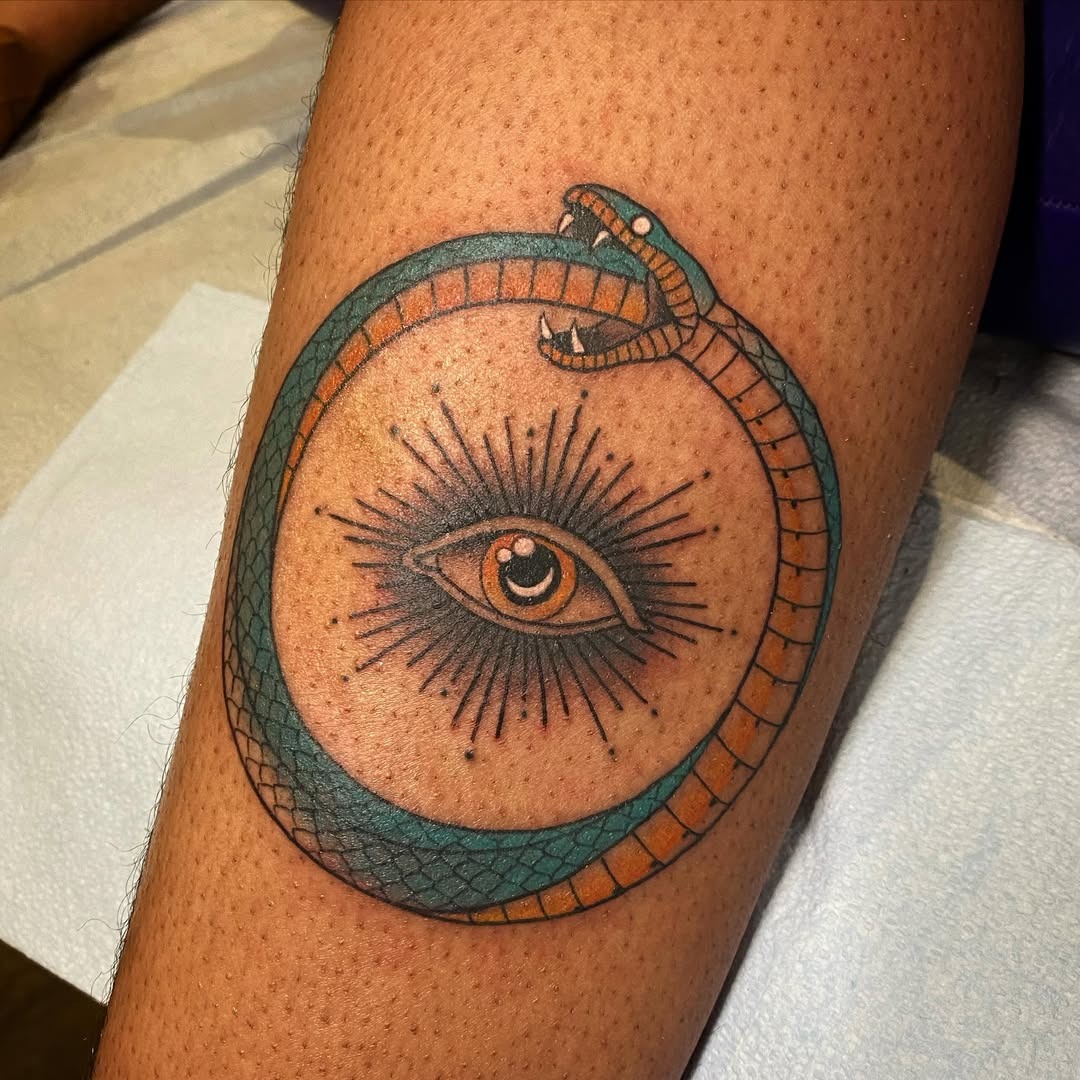 Vibrant ouroboros tattoo featuring mystical eye. Tattoo Design
