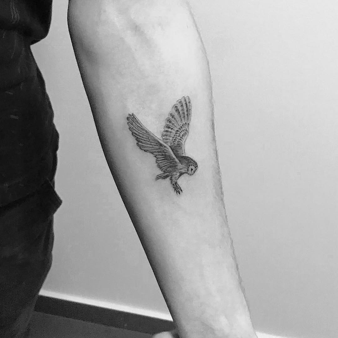 Intricate flying owl tattoo on forearm Tattoo Design