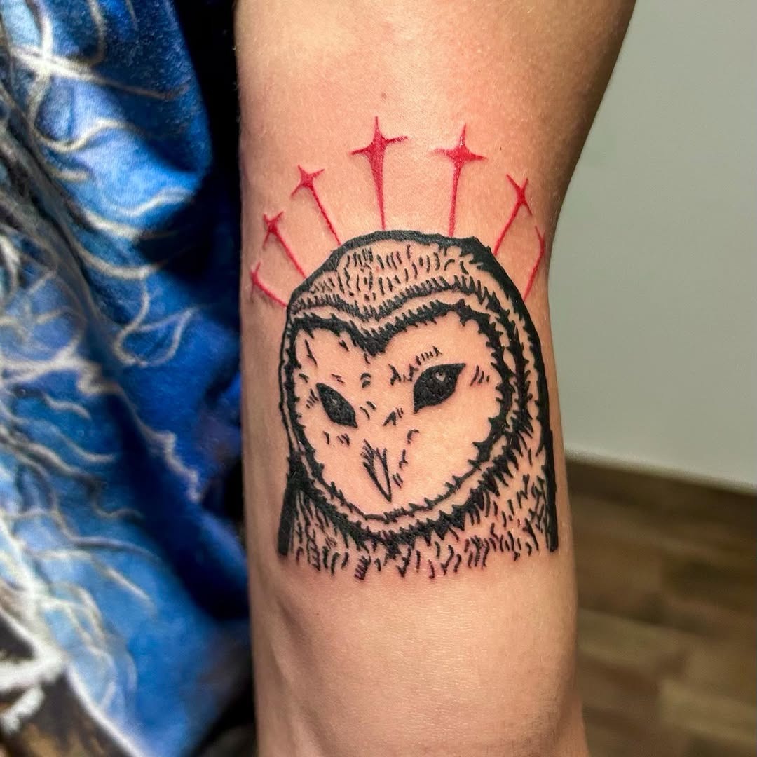 Minimalistic owl tattoo with vibrant star accents Tattoo Design
