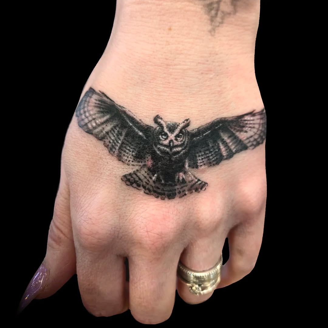 Striking owl tattoo in flight on hand Tattoo Design