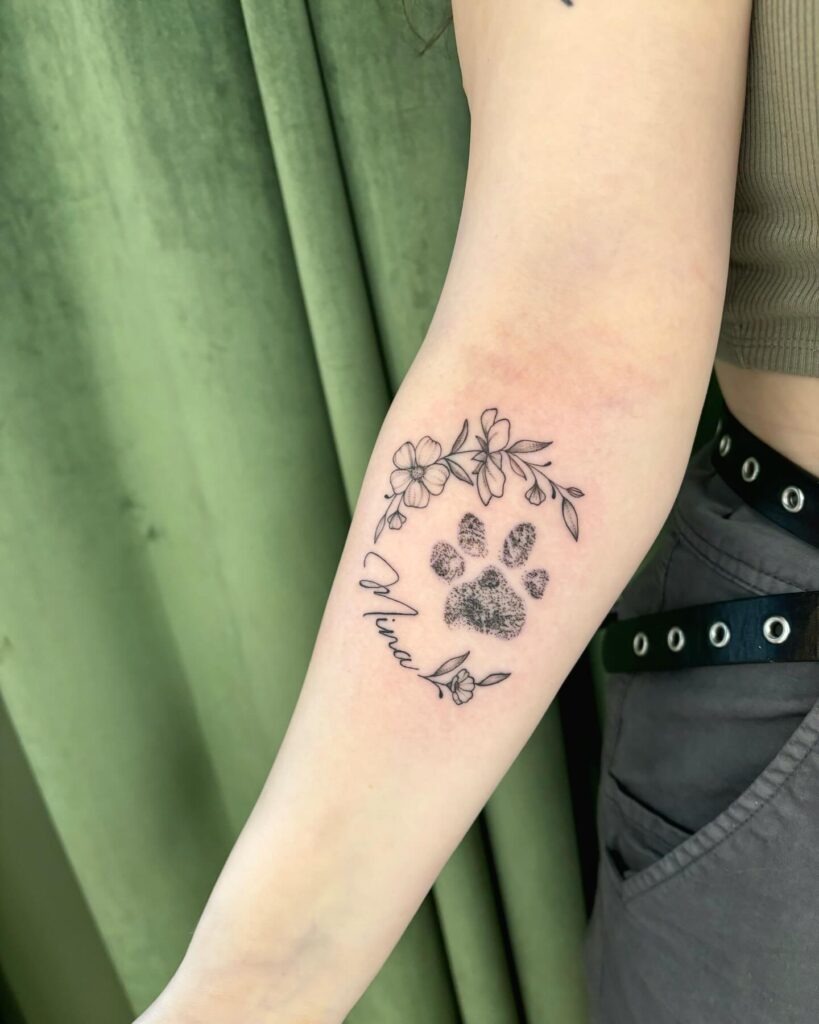 Paw Print Tattoo with Floral Accent and Name Tattoo Design