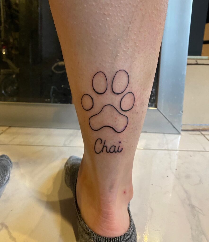 Simple Paw Print Outline Tattoo with Name Tattoo Design