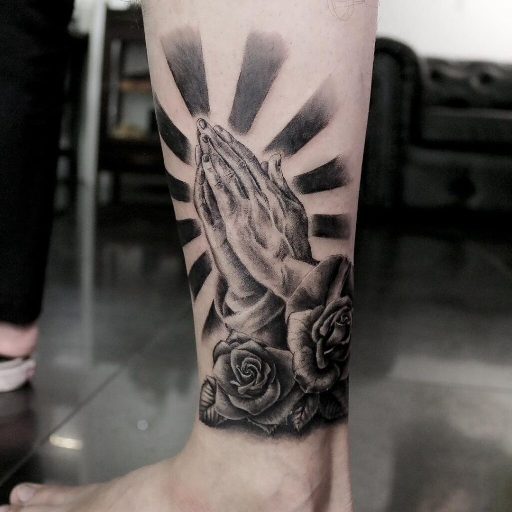 Praying Hands with Radiant Beams and Roses Tattoo Tattoo Design