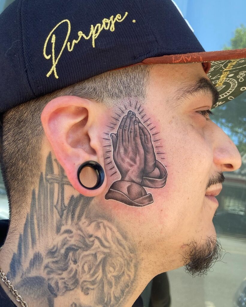 Praying Hands with Radiant Lines Face Tattoo Tattoo Design